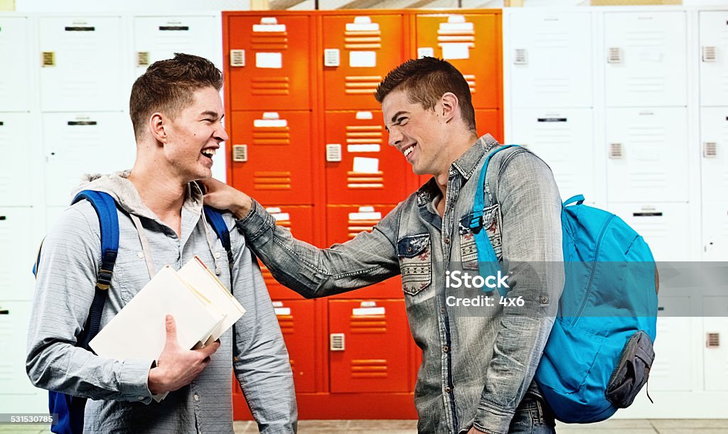 Two university students standing in front of lockers Two university students standing in front of lockershttp://www.twodozendesign.info/i/1.png 16-17 Years Stock Photo