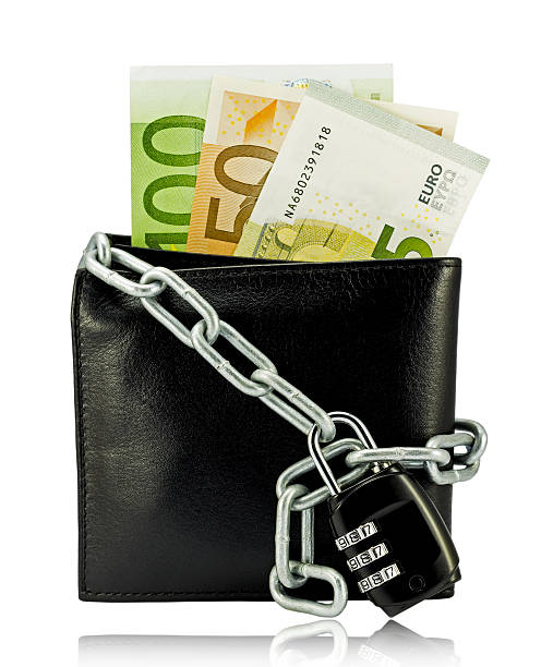 istock black wallet with money tied with chain and padlock 531531987