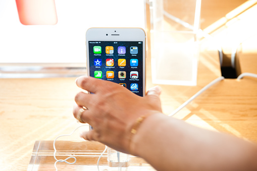 Paris, France - September 20, 2014: Hand holding a iPhone 6 Plus during the sales launch of the latest Apple Inc. smartphones at the Apple Store