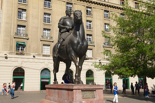 Santiago, Chile - October 16, 2013: Unidentified people walk near the equestrian monument to the 1st Royal Governor of Chile and founder of Santiago city don Pedro de Valdivia on October 16, 2013 in Santiago, Chile.