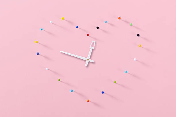 istock colorful pins made heart clock on pink background 531533275