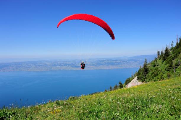 Paraglider above the French THULLON mountain Evian, France - June 21, 2014: Paraglider above the French THULLON mountain. evian les bains stock pictures, royalty-free photos & images