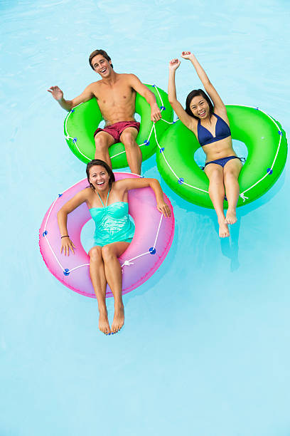istock Teenage friends floating on innertubes 531534145