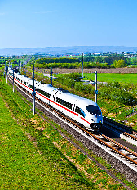 high speed train in open area high speed train with full speed in landscape passenger train stock pictures, royalty-free photos & images