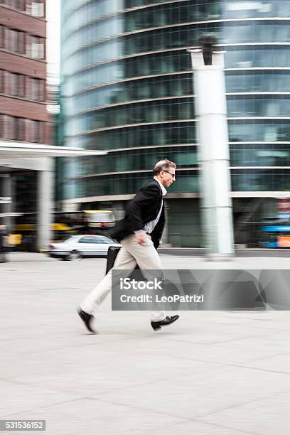 Senior Businessman Walking In The City Streets Stock Photo - Download Image Now - Confidence, Expertise, Finance