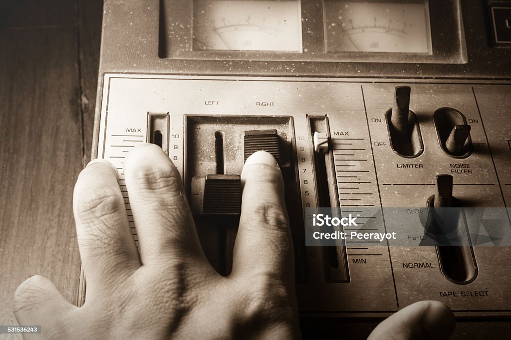 Human hand controlling radio sound,sepia filtered. Human hand controlling radio sound,sepia color filtered. 2015 Stock Photo