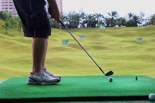 A golfer taking a practice shot at the driving range at IOI Golf Resort, Putrajaya.