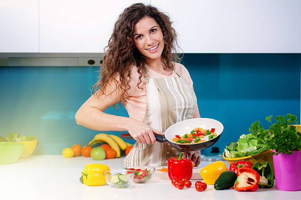 istock Young woman cooking in the kitchen 531537006