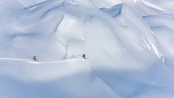 Two skiers back country skiing