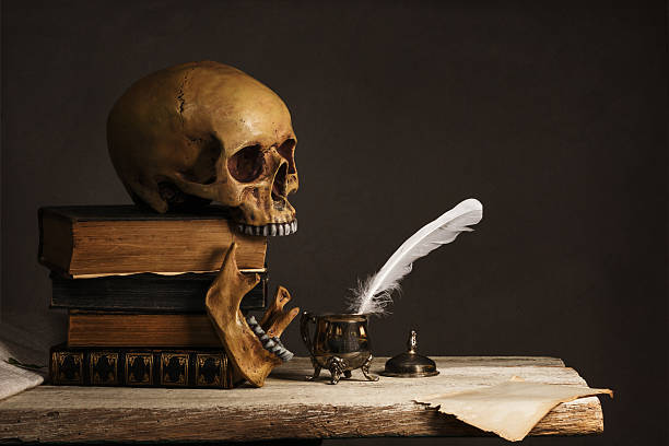 istock Skull on old Books with empty Page, Feather and Inkpot 531541314