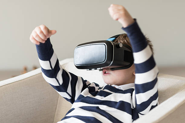 istock Little boy trying virtual reality eyeglasses device 531543720