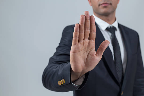 Businessman showing stop with hand Businessman showing stop with hand stop gesture photos stock pictures, royalty-free photos & images