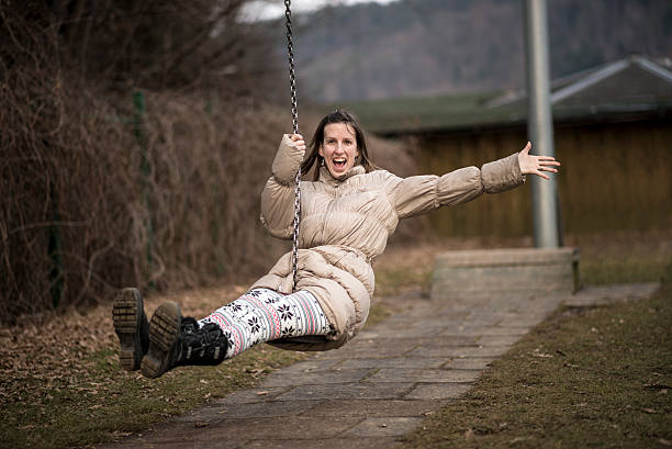 istock Young woman having fun on a swing 531549222