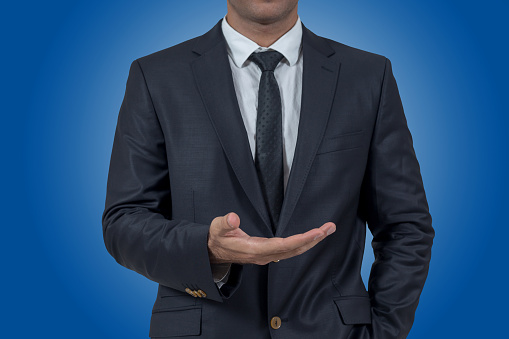 Empty hand of businessman on blue background