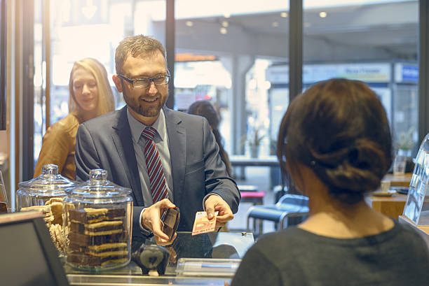 istock Male customer handing over a banknote 531552796