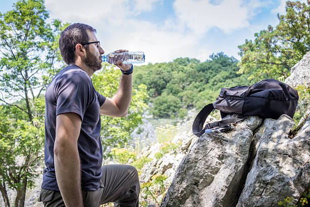 istock Hiker drinking water while resting in Great Outdoors 531554180