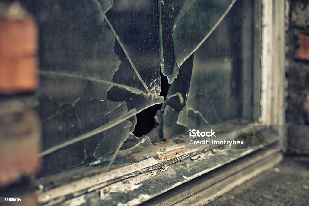 broken glass window reflecting clounding sky Window Stock Photo