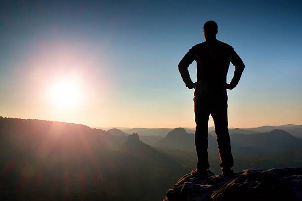 istock Silhouette of Young Confident Man Standing with Hands on Hips 531556246