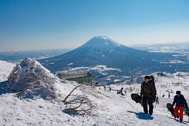 Snowboarders Hike up the Backcountry Trail at Niseko United Niseko, Hokkaido, Japan - February 27, 2016: Snowboarders Hike up the Backcountry Trail at Mt Annupuri, Part of the Niseko United Ski Resort japanese snowboarder stock pictures, royalty-free photos & images