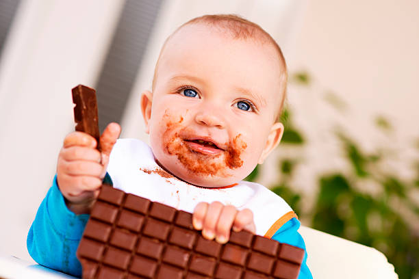 istock Baby boy eating chocolate 531558538