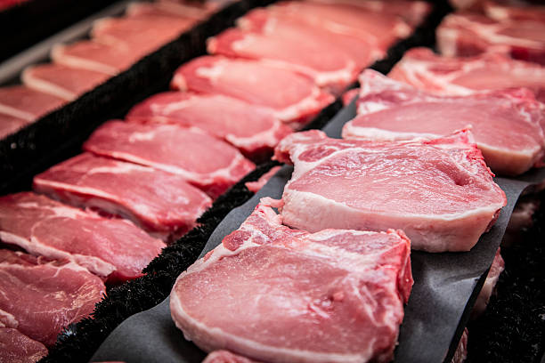 Meat Department at grocery store with steaks on display in cooler
