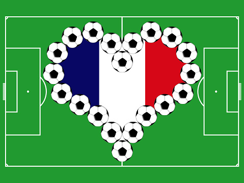 Soccer balls as the heart in colors of the flag of France on the background of the playing field