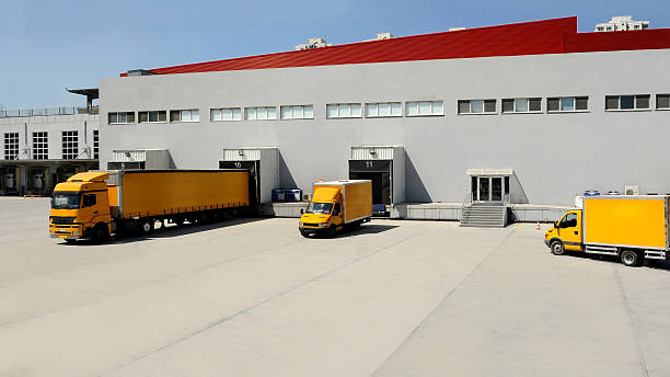 istock Yellow Transport Truck Docking in Warehouse 531562584