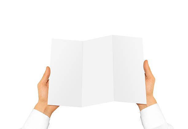 istock Hand holding blank brochure booklet in the hand. Leaflet presentation 531563368