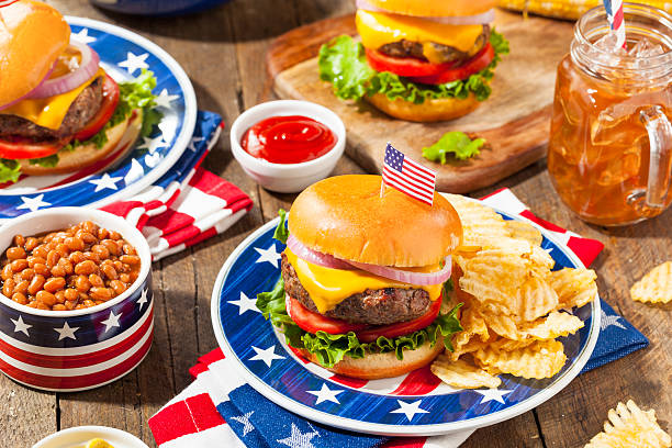 Homemade Memorial Day Hamburger Picnic Homemade Memorial Day Hamburger Picnic with Chips and Fruit july photos stock pictures, royalty-free photos & images