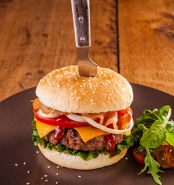 istock Delicious juicy hamburger served with a knife 531565508