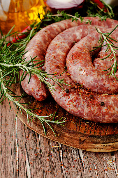 istock raw beef sausages on a cast-iron pan,  selective focus 531566540