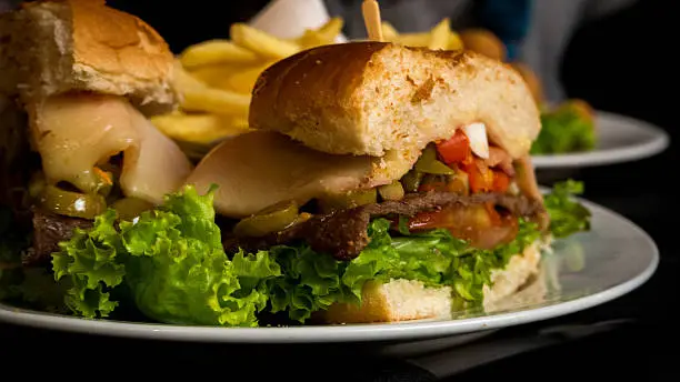 Chivito is an uruguayan beef sandwich, that includes lettuce, tomato, bacon, ham, red pepper, fried eggs, mozzarella cheese, olives and depending on the restaurant more ingredients.