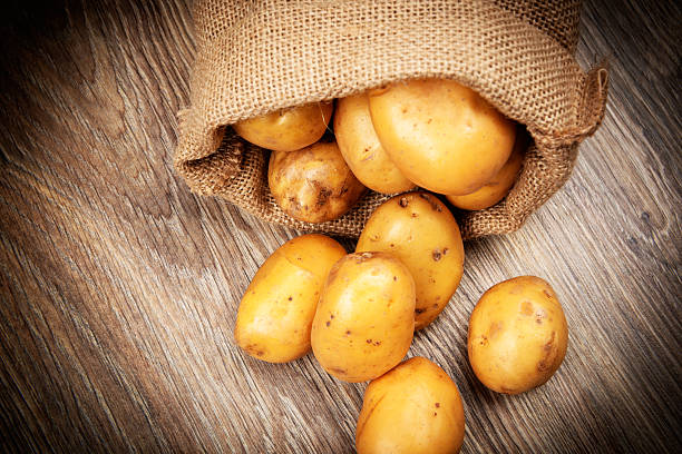 Raw potatoes in the sack stock photo