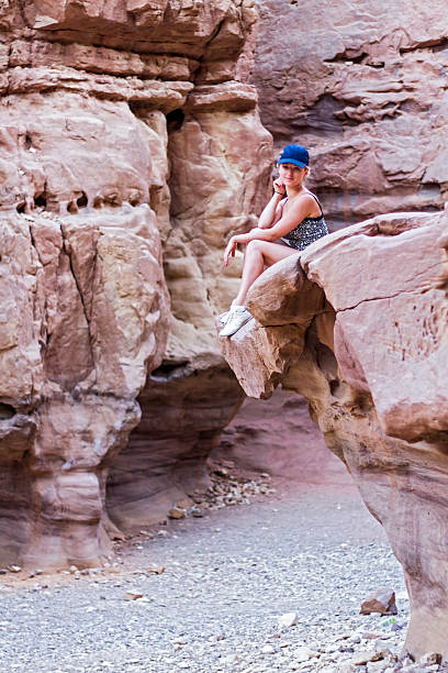 istock girl sitting on a rock 531568077