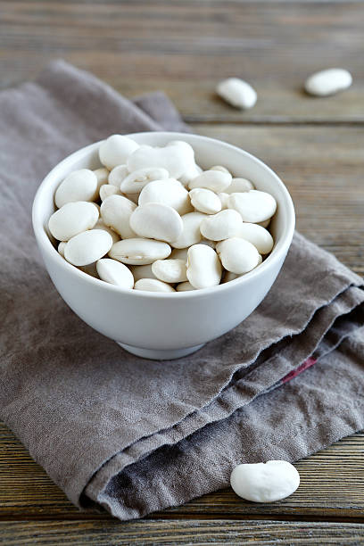 istock Dry white beans in bowl on a linen napkin 531570019