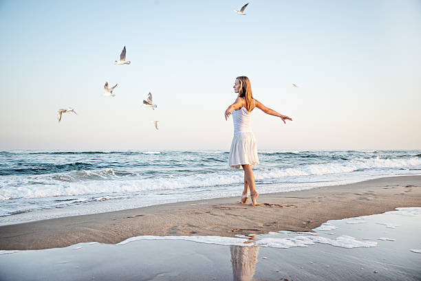 istock Girl standing at the beach 531570047