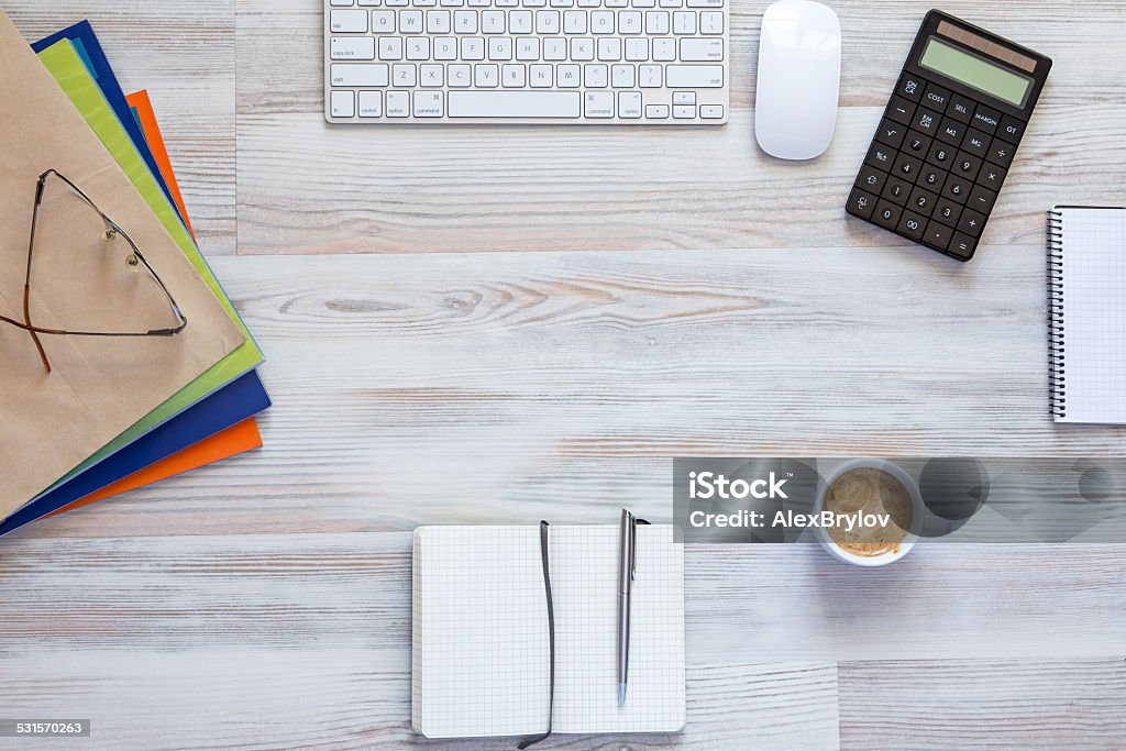 Office workplace at morning Well organised workspace on the grey wooden table with keyboard, pens, coffee mug and other business supplies 2015 Stock Photo