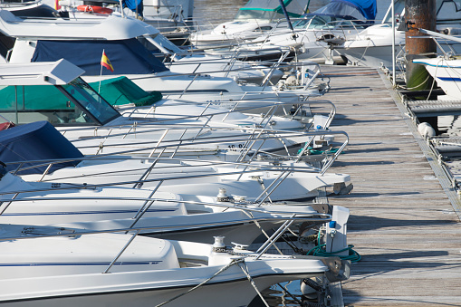 different types of yachts docked in the port