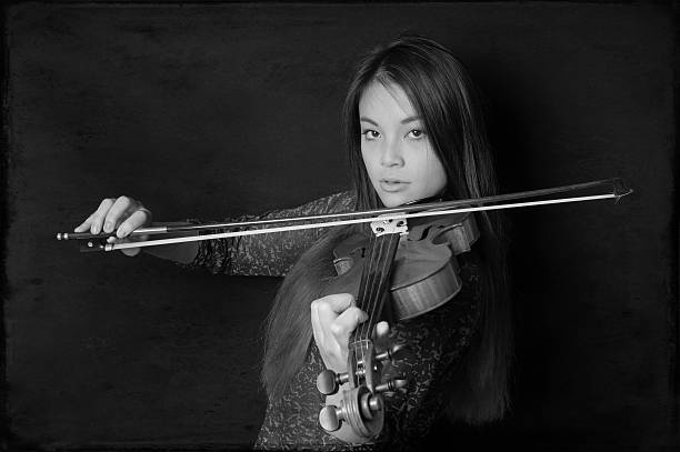 istock young asian woman playing violin 531571453