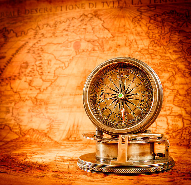 istock Vintage compass lies on an ancient world map. 531571967