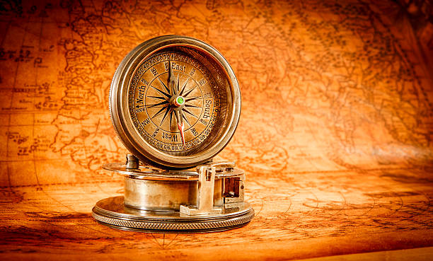 istock Vintage compass lies on an ancient world map. 531572221