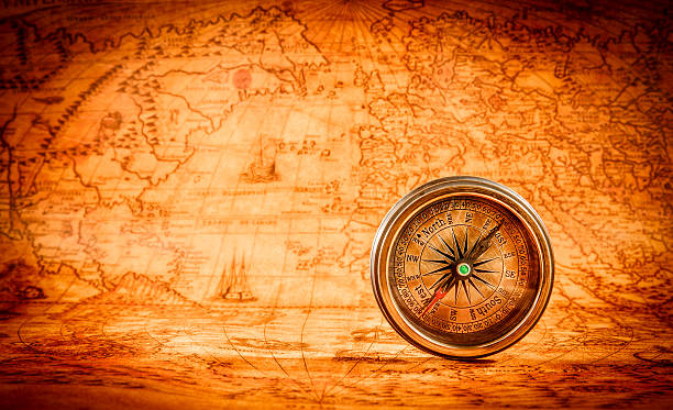 istock Vintage compass lies on an ancient world map. 531579877