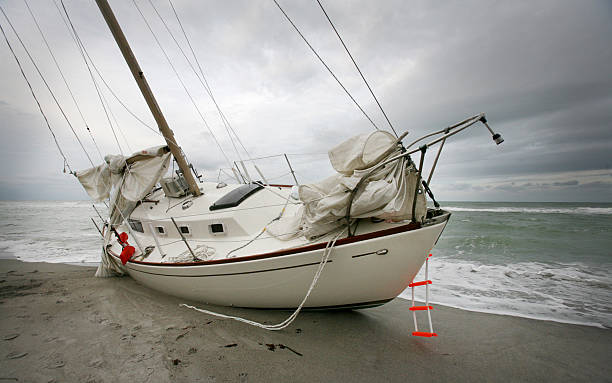 istock Grounded Boat Sailboat in a Storm on a Beach 531594473