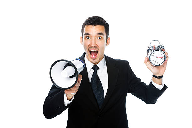 istock man with megaphone and alarm clock 531595091