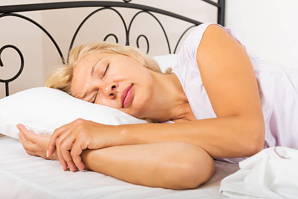 istock Mature woman in pajamas sleeping 531596625