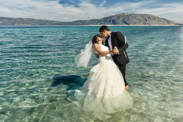 istock Bride and groom dancing on the beach 531598263