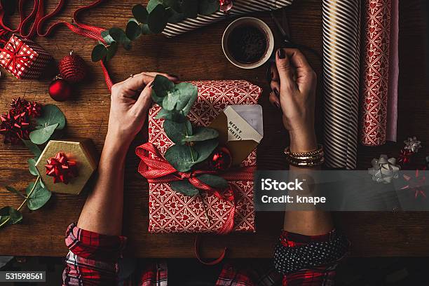 Woman Packing Contemporary Christmas Gifts Stock Photo - Download Image Now - Christmas Present, Wrapping, Adult