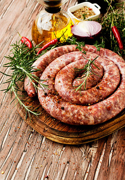 istock raw beef sausages on a cast-iron pan,  selective focus 531602864