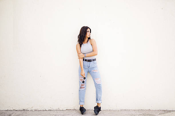 istock Beautiful female fashion model posing on wall 531602932
