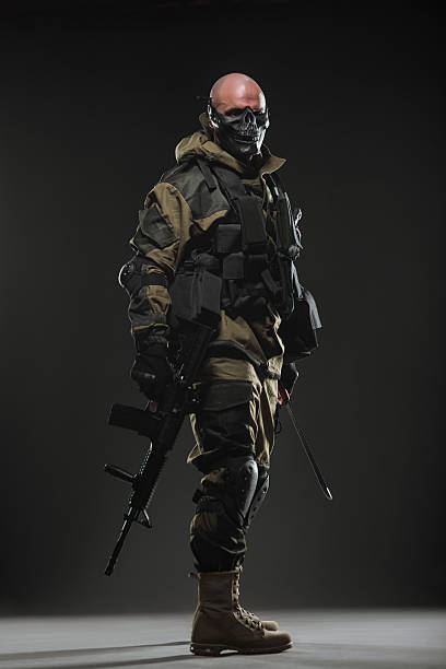 istock soldier man hold Machine gun on a  dark background 531605056